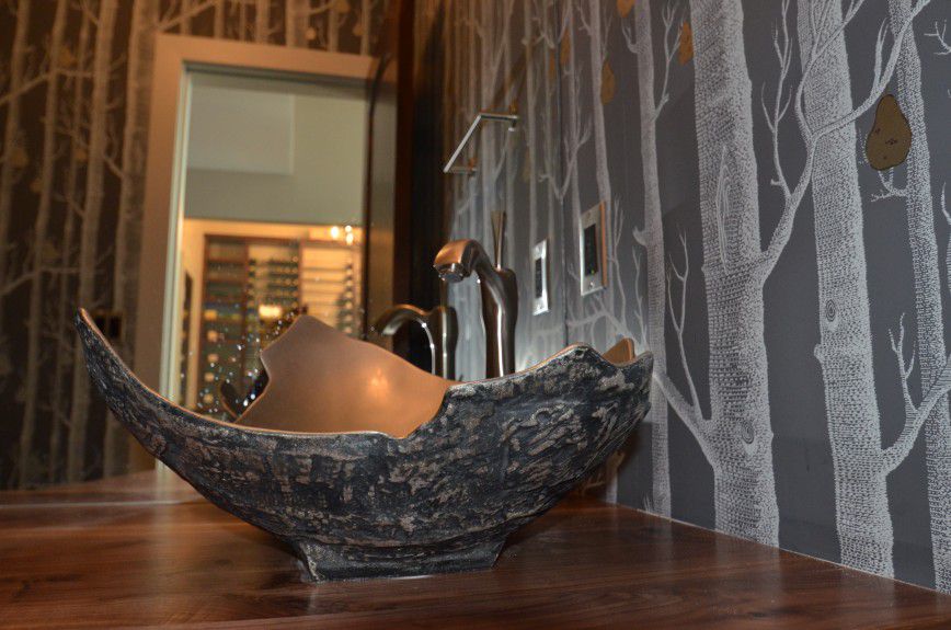 interior-designers-denver - A bronze challis sink with a tree wallpaper and matching pears in a powder room designed by Runa Novak of In Your Space Interior Design
