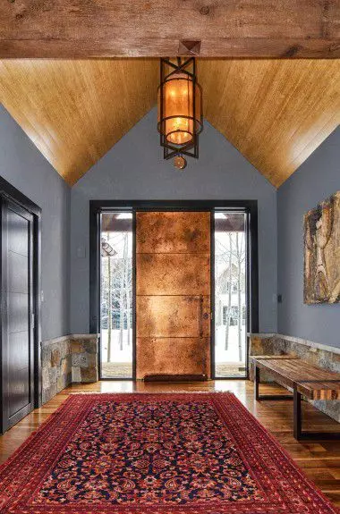 interior-design-aspen - A Foyer with a custom copper entry door with a hand blown glass chandelier and exterior stone half wall in Aspen Valley designed by Runa Novak of In Your Space Interior Design - demo.mightymediatech.com and RunaNovak.com